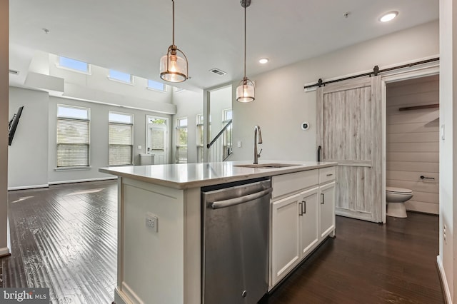 543 Leftwich Ln, Annapolis, MD 21401 - kitchen with dishwasher, a sink, dark wood-style flooring, a barn door, and white cabinetry