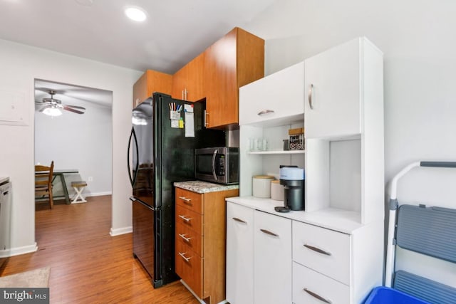 5608 Bismach Dr Unit 103, Alexandria, VA 22312 - kitchen featuring stainless steel microwave, light wood-type flooring, baseboards, a ceiling fan, and light countertops