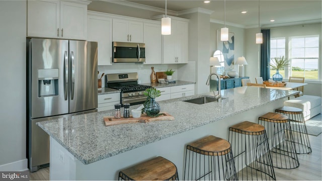 6825 Winterhill Ln, Glen Burnie, MD 21060 - kitchen with a breakfast bar, a sink, white cabinetry, and appliances with stainless steel finishes