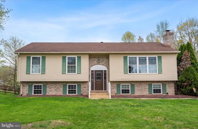 128 Pinion Pl, Bear, DE 19701 - split foyer home with brick siding, a chimney, a front lawn, and a shingled roof