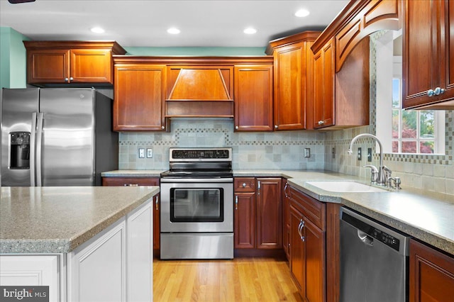 128 Pinion Pl, Bear, DE 19701 - kitchen with tasteful backsplash, a sink, light wood-type flooring, stainless steel appliances, and wall chimney exhaust hood