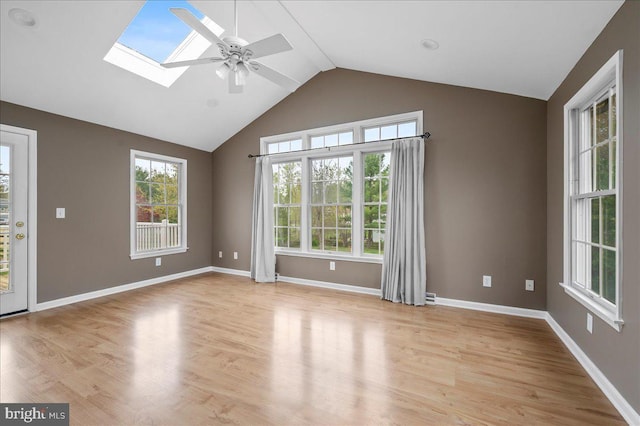 128 Pinion Pl, Bear, DE 19701 - empty room with light wood-style flooring, baseboards, lofted ceiling with skylight, and ceiling fan