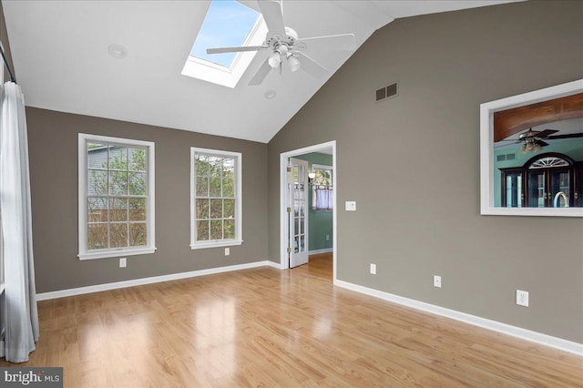128 Pinion Pl, Bear, DE 19701 - unfurnished room featuring light wood finished floors, visible vents, a ceiling fan, a skylight, and high vaulted ceiling