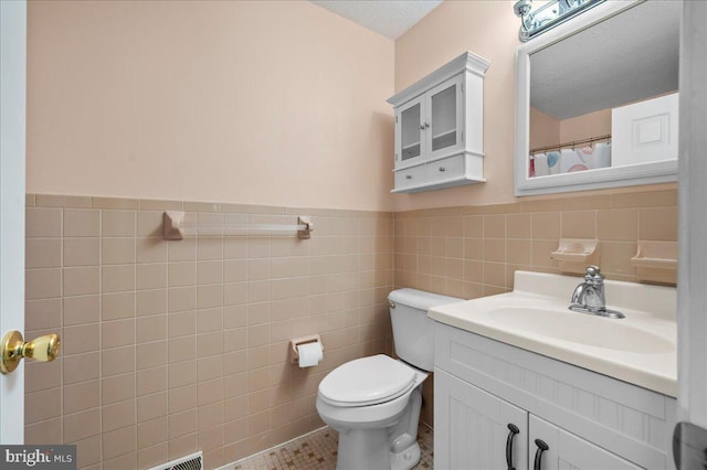 128 Pinion Pl, Bear, DE 19701 - bathroom featuring a wainscoted wall, tile patterned floors, toilet, vanity, and tile walls