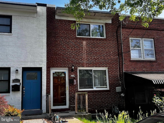 view of property featuring brick siding