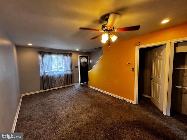interior space with carpet flooring, recessed lighting, ceiling fan, and baseboards