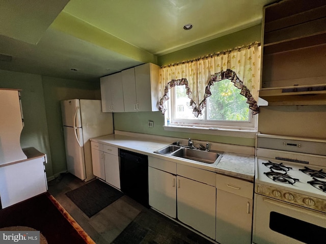 kitchen with white appliances, white cabinetry, a sink, and light countertops