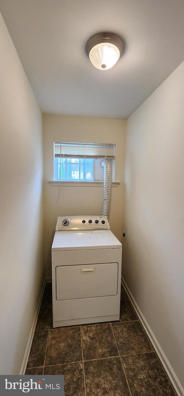 335 Paradee Dr, Dover, DE 19904 - washroom featuring washer / dryer and dark tile patterned flooring