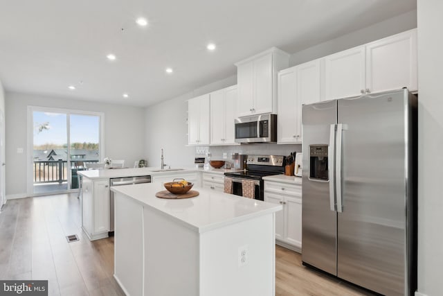 7828 Yona Ct, Glen Burnie, MD 21060 - kitchen featuring stainless steel appliances, a sink, a peninsula, light wood-style floors, and recessed lighting