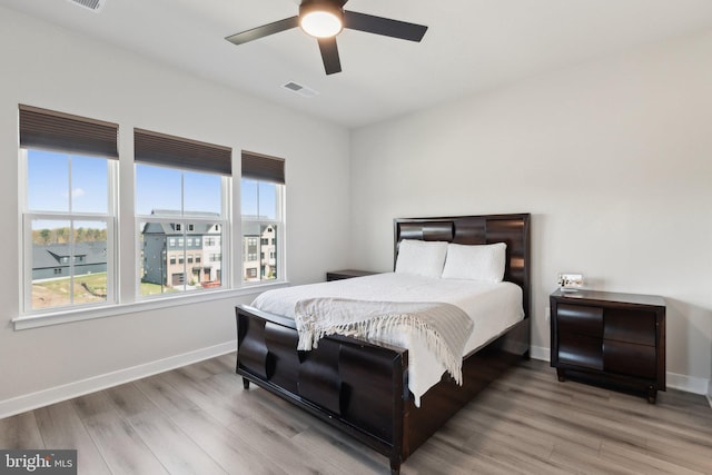 7828 Yona Ct, Glen Burnie, MD 21060 - bedroom featuring multiple windows, wood finished floors, and baseboards