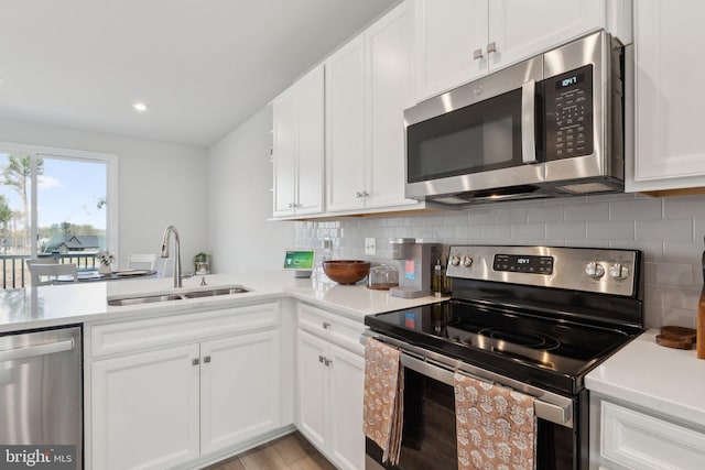 7828 Yona Ct, Glen Burnie, MD 21060 - kitchen featuring stainless steel appliances, a sink, light countertops, decorative backsplash, and recessed lighting