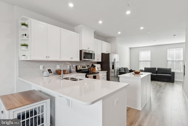 7828 Yona Ct, Glen Burnie, MD 21060 - kitchen with appliances with stainless steel finishes, a sink, open shelves, a center island, and tasteful backsplash