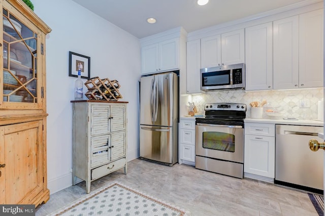 3275 Sutton Pl NW Unit C, Washington, DC 20016 - kitchen featuring light countertops, white cabinets, stainless steel appliances, and decorative backsplash