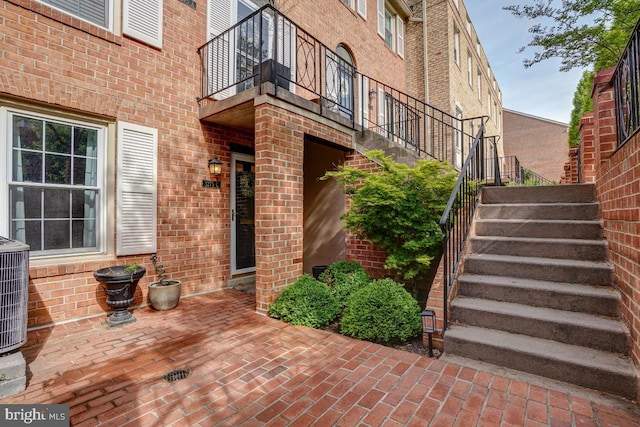 3275 Sutton Pl NW Unit C, Washington, DC 20016 - doorway to property with central air condition unit, a balcony, a patio, and brick siding