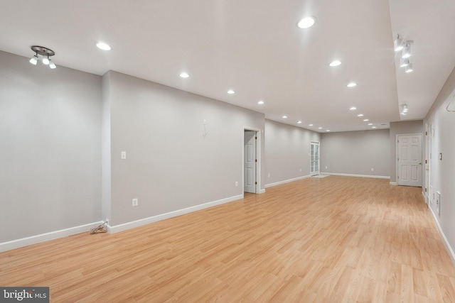 basement with recessed lighting, light wood-style flooring, and baseboards
