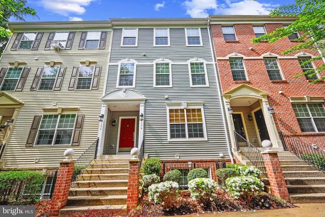 townhome / multi-family property featuring brick siding