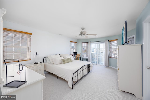 bedroom featuring light colored carpet, baseboards, and a ceiling fan
