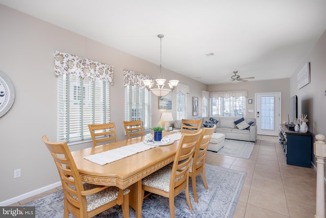 dining area with ceiling fan with notable chandelier, visible vents, baseboards, and light tile patterned floors