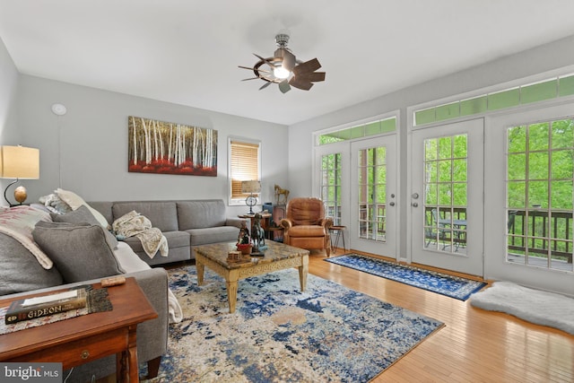 living room with wood finished floors and ceiling fan