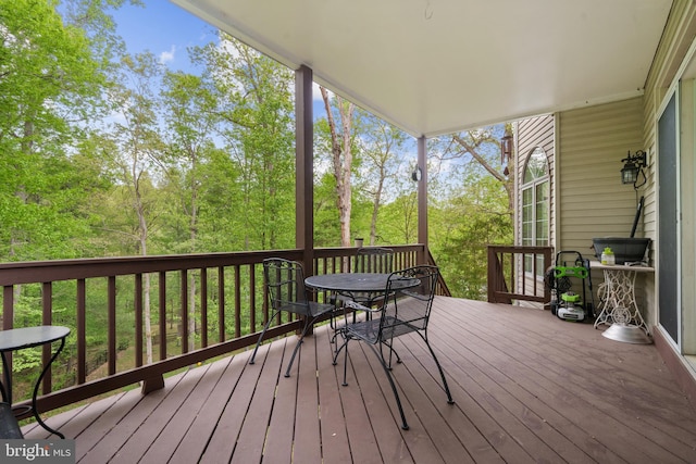 wooden terrace with outdoor dining area