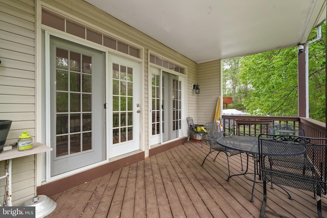 wooden terrace featuring outdoor dining space