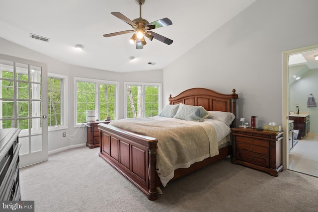 bedroom featuring visible vents, light carpet, and lofted ceiling