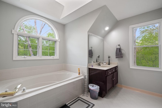 bathroom featuring tile patterned flooring, a bath, and vanity
