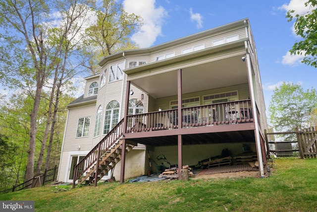 back of house featuring stairway, fence, a wooden deck, and a lawn