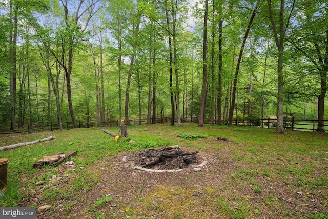 view of yard with fence and a view of trees