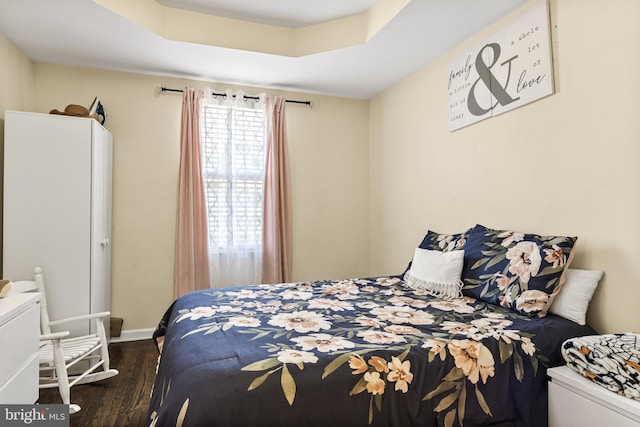 bedroom with baseboards and wood finished floors