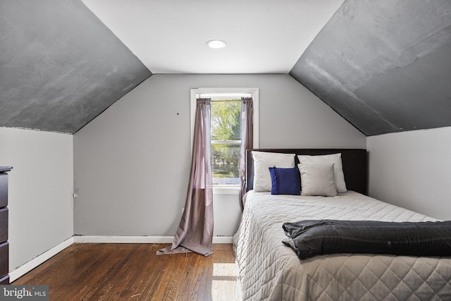 bedroom with wood-type flooring, baseboards, and lofted ceiling