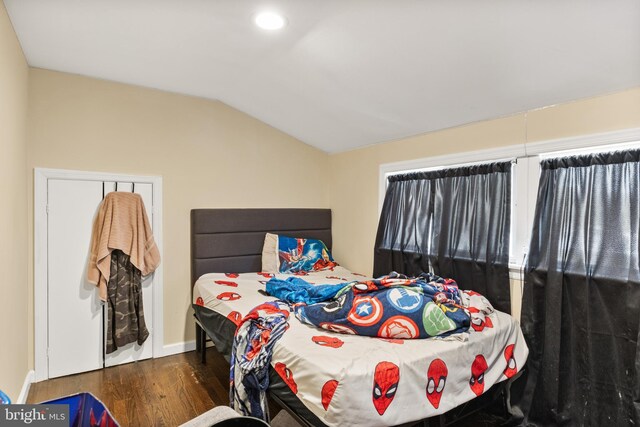 bedroom with baseboards, recessed lighting, wood finished floors, and vaulted ceiling