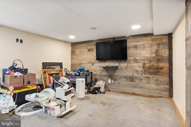 below grade area with wooden walls, recessed lighting, and baseboards