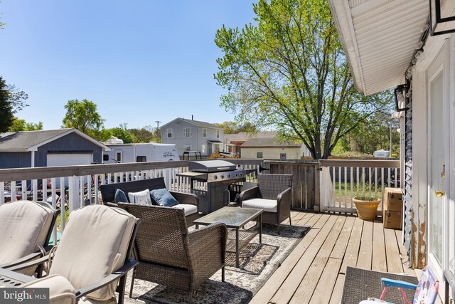 wooden terrace featuring a residential view and an outdoor living space
