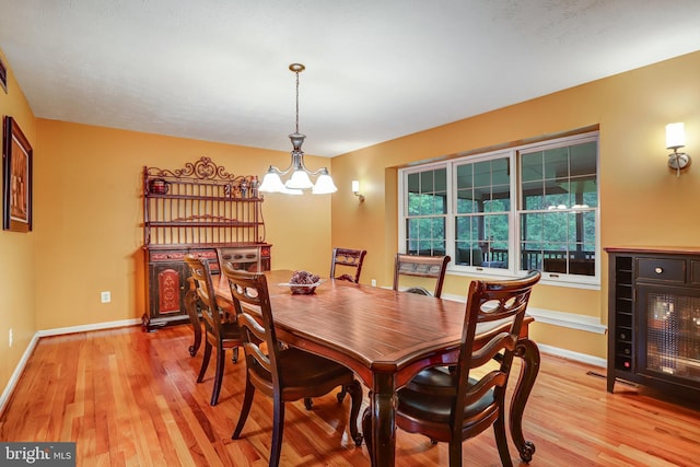 4985 Tall Oaks Dr, Monrovia, MD 21770 - dining space featuring light wood-style flooring, baseboards, and a notable chandelier