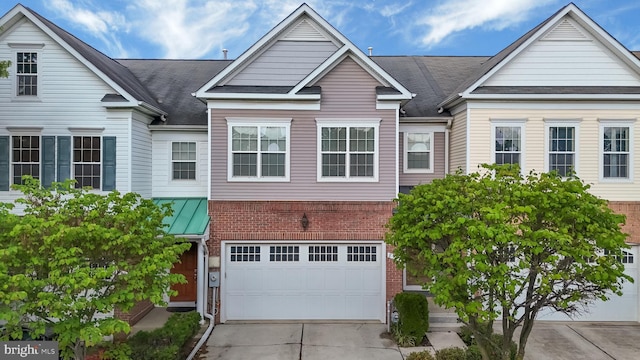 8507 Young Rivers Ct Unit 22, Laurel, MD 20723 - view of front facade featuring brick siding, driveway, a garage, and a shingled roof