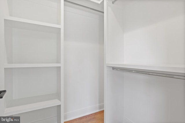 walk in closet featuring light wood finished floors