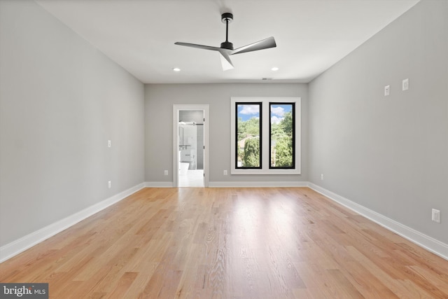 unfurnished bedroom with baseboards, ensuite bathroom, light wood finished floors, and recessed lighting