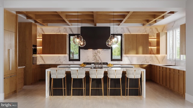 kitchen featuring brown cabinetry, modern cabinets, and a sink