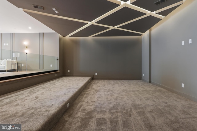 home theater room featuring baseboards, visible vents, and carpet floors