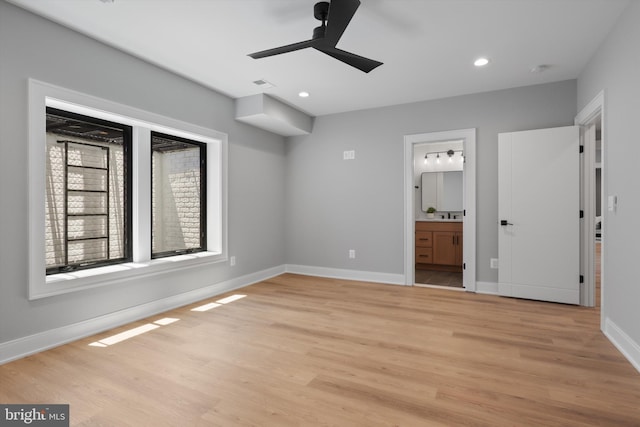 unfurnished bedroom featuring light wood-type flooring, baseboards, recessed lighting, visible vents, and connected bathroom