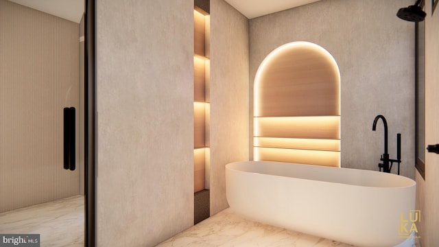 interior space featuring a soaking tub and marble finish floor
