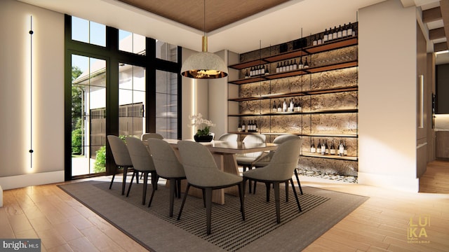 dining area featuring a high ceiling and wood finished floors