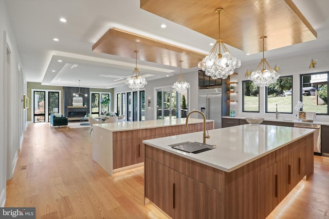 kitchen featuring a chandelier, a spacious island, appliances with stainless steel finishes, and modern cabinets