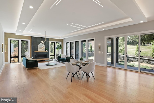 dining area with plenty of natural light, baseboards, recessed lighting, and a raised ceiling