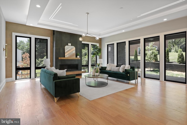 living room with a tray ceiling and a wealth of natural light