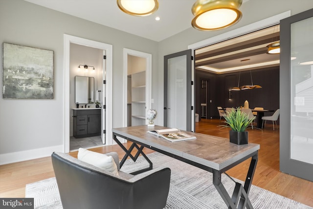 home office with light wood finished floors and baseboards