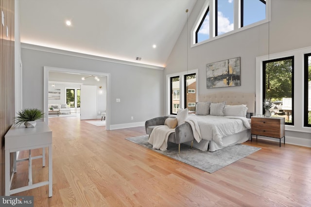 bedroom featuring light wood finished floors, baseboards, visible vents, recessed lighting, and high vaulted ceiling