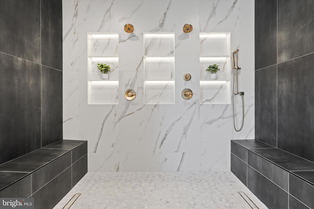 full bathroom featuring a marble finish shower