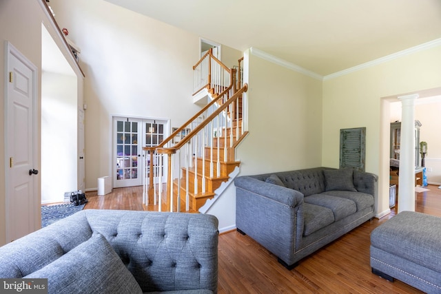 350 Rotterham Dr, Hedgesville, WV 25427 - living room with decorative columns, stairs, baseboards, ornamental molding, and wood finished floors